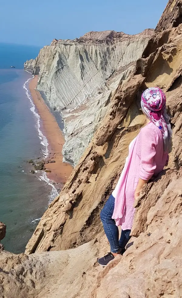 منظره غروب آفتاب در ساحل مفنق هرمز با آبهای آرام و صخرههای مرجانی